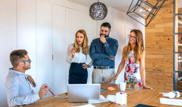 Management team congratulating an employee