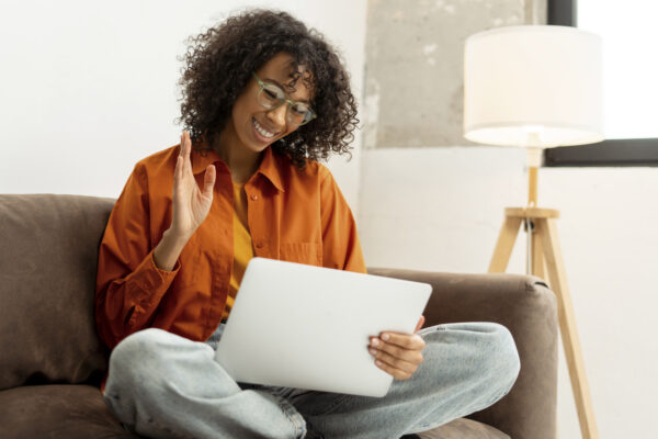 African American woman using laptop having video call. Blogger influencer communication online