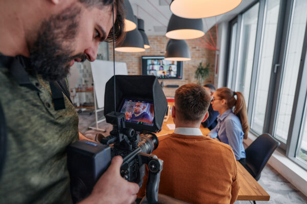 Capturing Corporate Dynamics: Videographer Films Business Meeting in Modern Office.